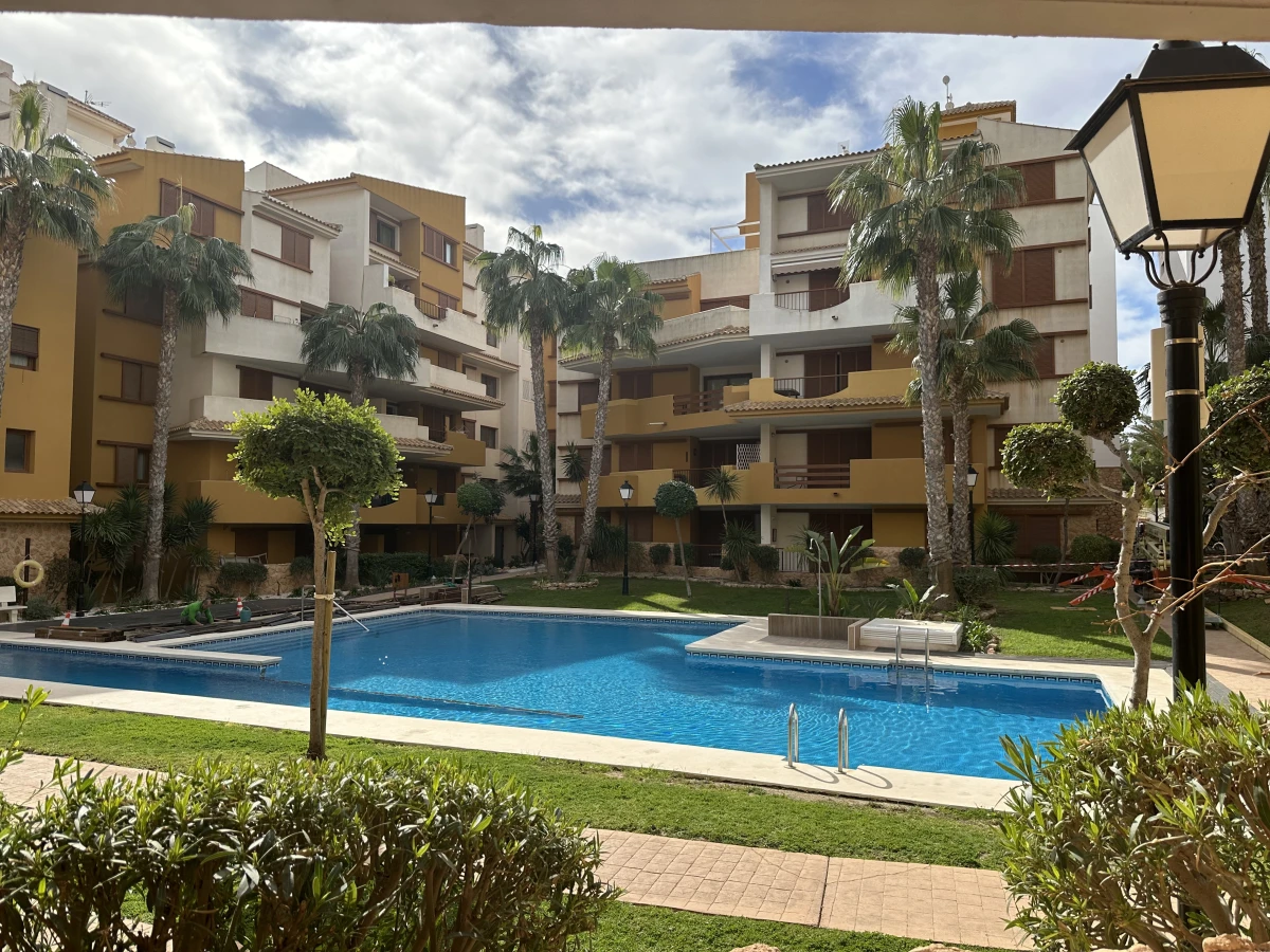 Ground floor Punta Prima apartament looking at the pool